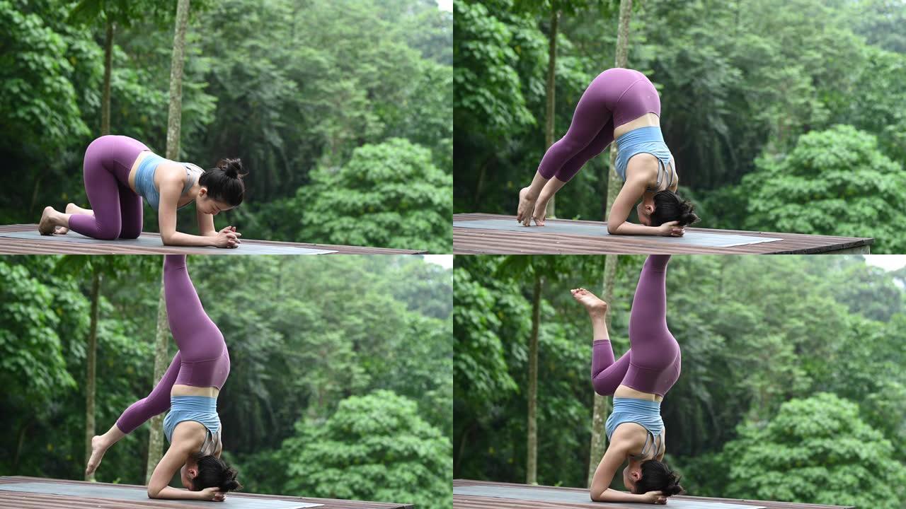一位亚洲中国瑜伽教练在木制平台上的森林中摆姿势