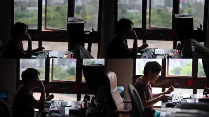 一位亚洲华人中年女性，在她的家庭办公室台式机前工作