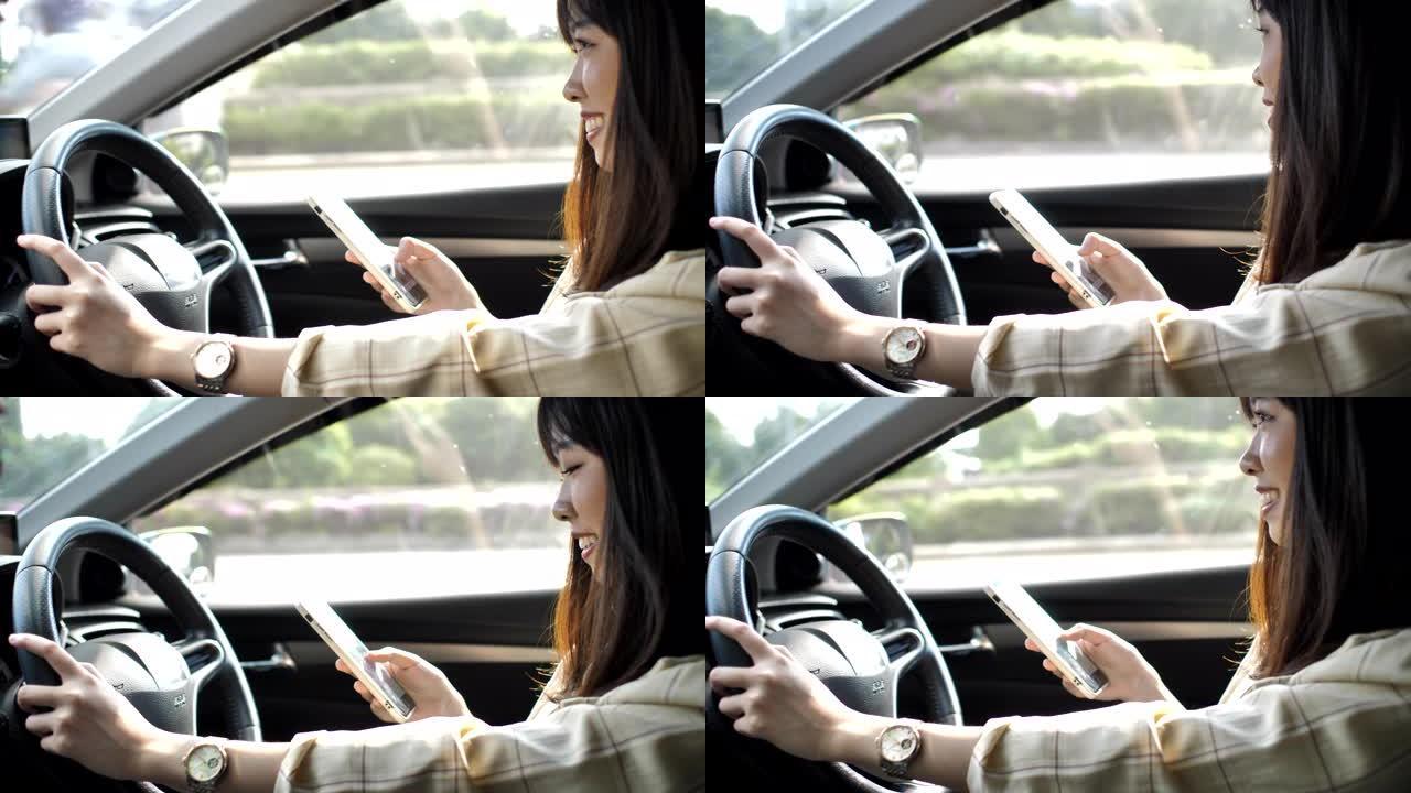 亚洲妇女在开车时用智能手机发短信