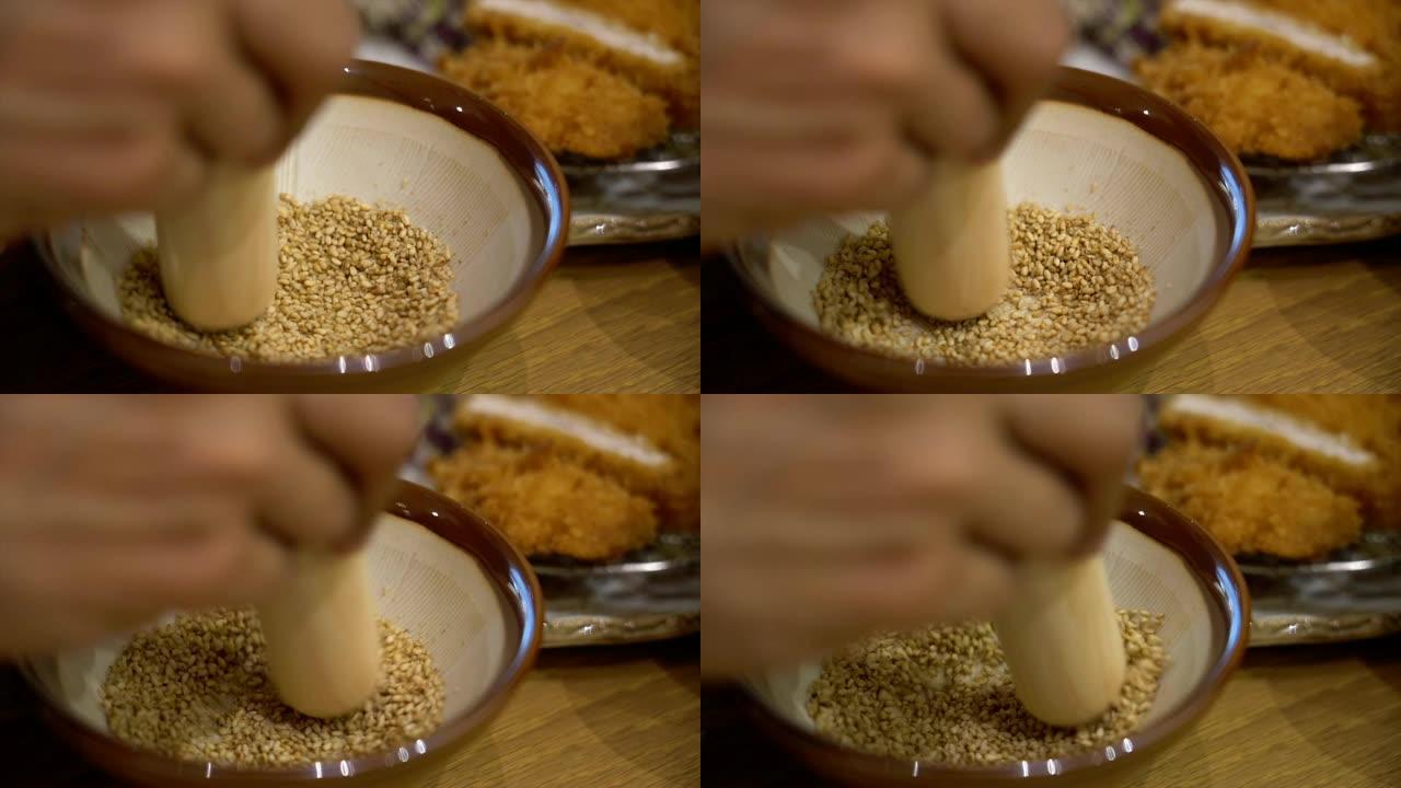 4k慢动作镜头场景手工研磨白芝麻辣酱的特写镜头，日本食品和配料概念