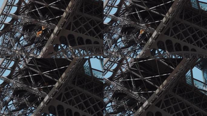 在巴黎史诗般的埃菲尔铁塔钢结构内向上移动的缆车上，电影般的宽镜头移动。