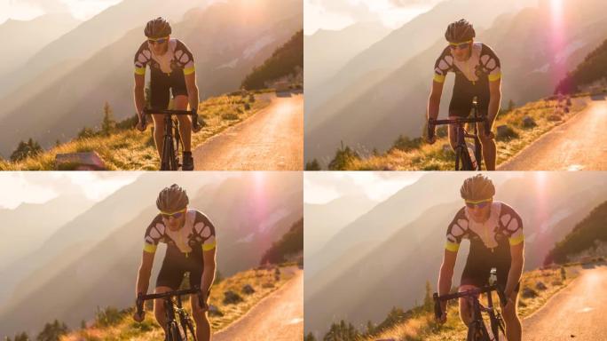 男子公路骑自行车的人在山路上骑自行车，被阳光照亮
