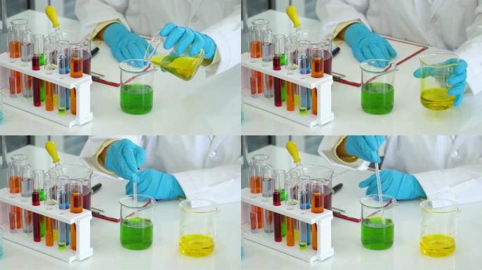 4k: 科学家在实验室的烧杯中分析和混合液体。