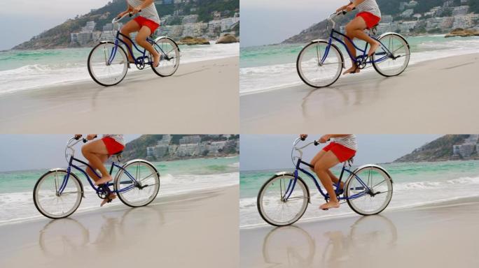 在海滩上骑自行车的人的低矮部分4k