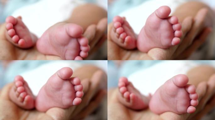 妈妈手中的小脚人类幼崽婴儿小脚丫特写