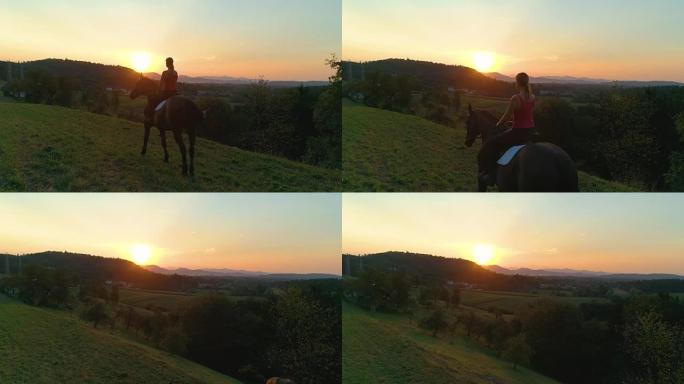 空中: 坐在马背上看着日出的年轻女孩