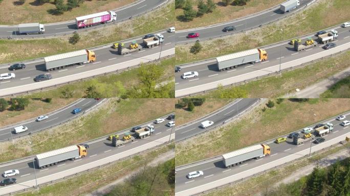 空中: 两辆卡车在交通拥堵时沿着高速公路行驶。