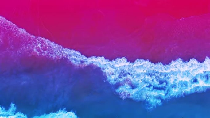 明亮多彩的海滩俯视图，紫外线霓虹色。不同寻常的颜色组合。神奇的氛围。空中4k慢动作