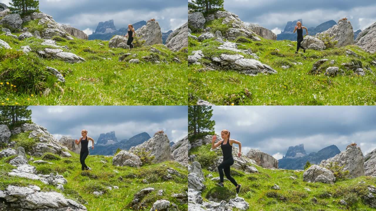 快乐女运动员在山腰的绿色草地上跑步