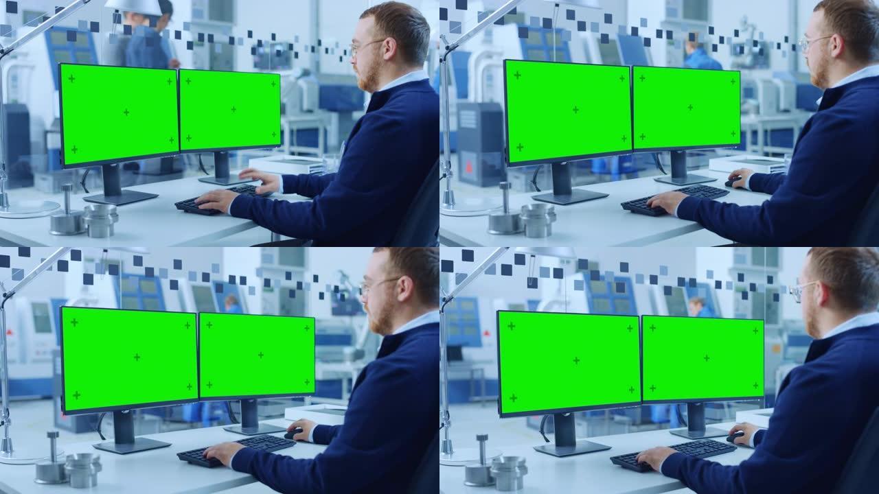 在个人计算机上工作的工业工程师，两个监视器屏幕是模型，绿色屏幕，色度键显示。拥有高科技机械的现代化工