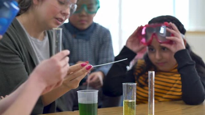 老师和学生在教室里做化学实验。