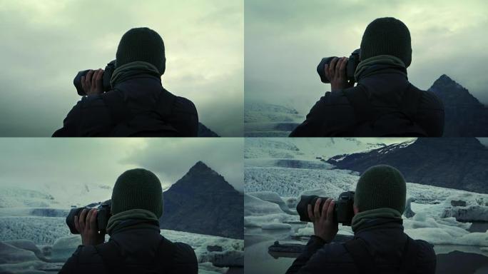 摄影师在冰川泻湖。日落