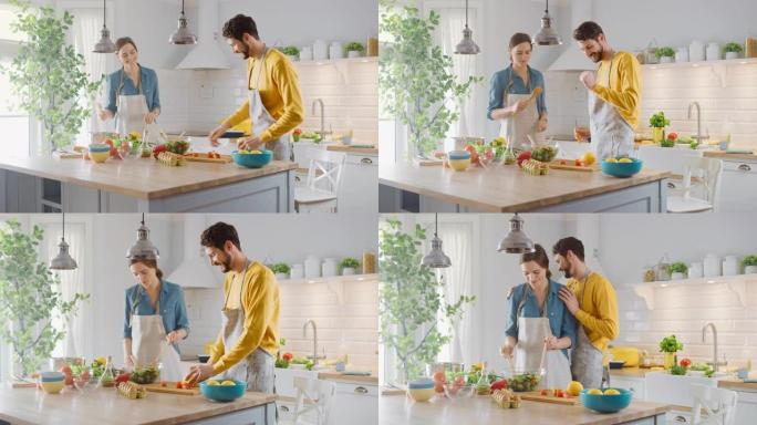 在厨房: 幸福的夫妻准备健康的食物，大量的蔬菜。男人玩水果，让她的女朋友笑。恋爱中可爱的人玩得开心