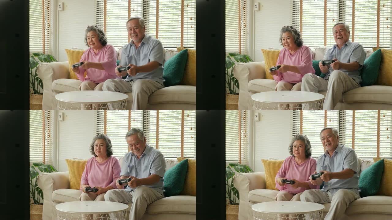 亚洲老年夫妇在家里一起玩游戏，情绪愉快。人们有放松、老年、退休、老年生活方式的家庭观念。