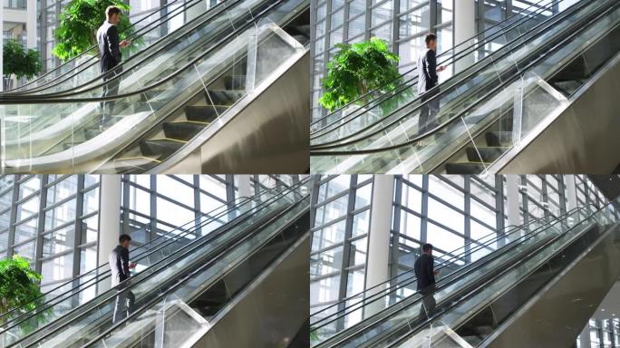 现代建筑中的自动扶梯上的年轻商人