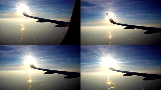 4k倾斜拍摄日落之前的早晨天空，飞行的飞机机翼