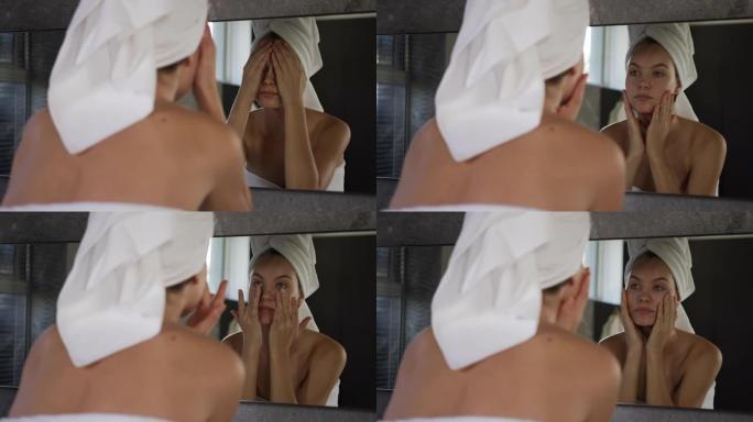 在酒店洗完澡后照镜子的白人妇女