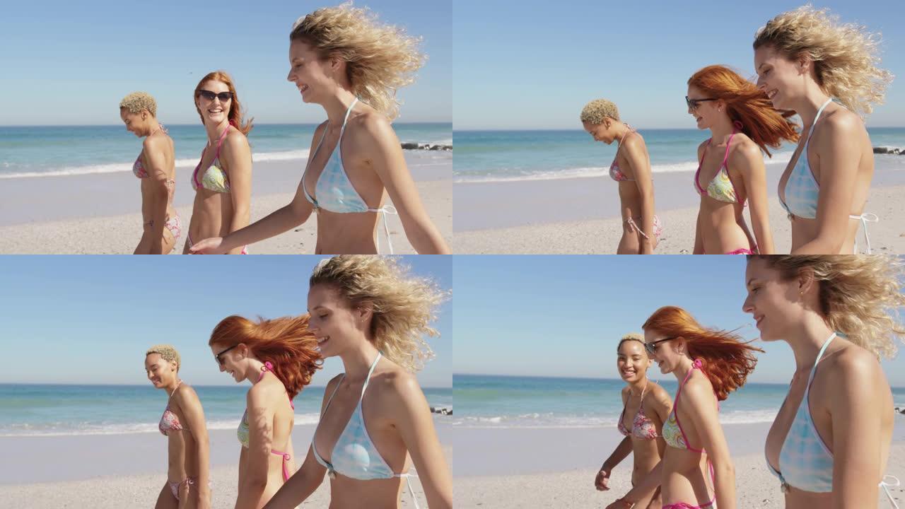 年轻的成年女性朋友在海滩上散步4k