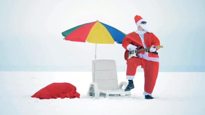圣诞老人在他的躺椅旁边弹吉他