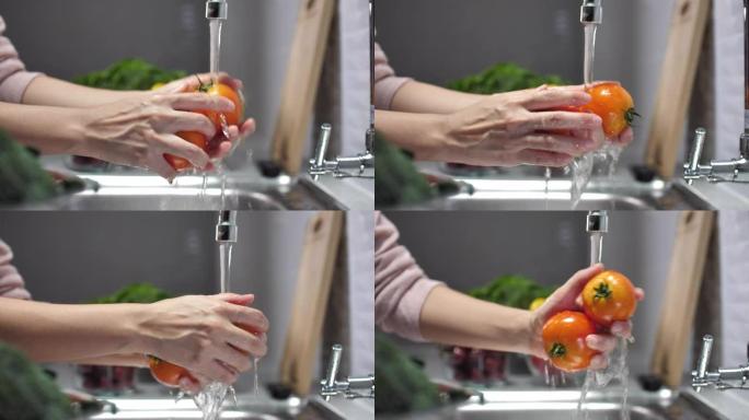 女人洗新鲜西红柿的特写镜头