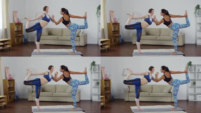 练习双人舞者瑜伽姿势的女性伴侣