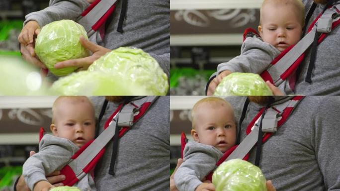 好奇的婴儿在超市触摸白菜