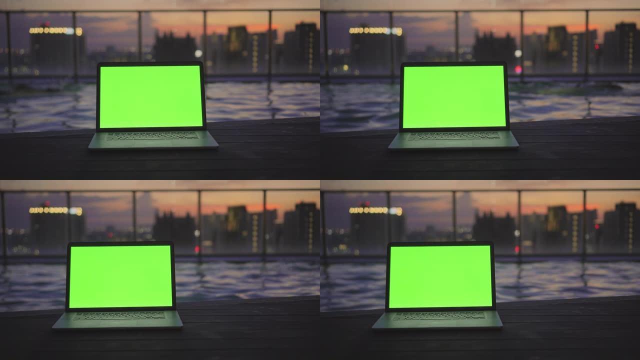 屋顶游泳池绿屏笔记本电脑的多莉镜头，没有人