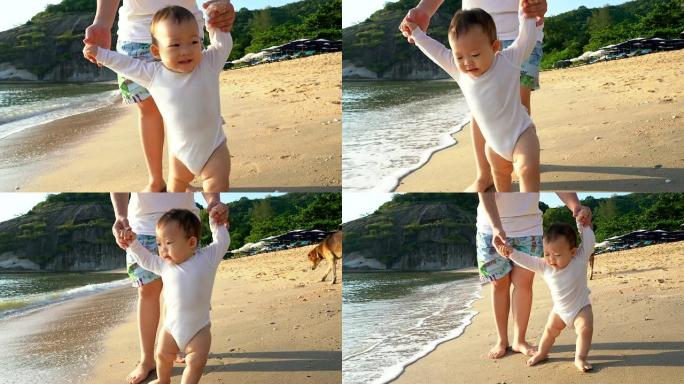 家庭，孩子，童年和父母的概念-快乐的小婴儿在海滩上学习与母亲的帮助走路。