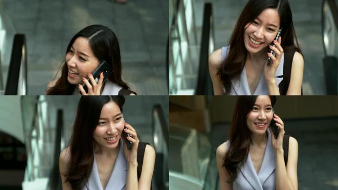 年轻漂亮的女人用手机聊天，情绪愉快。