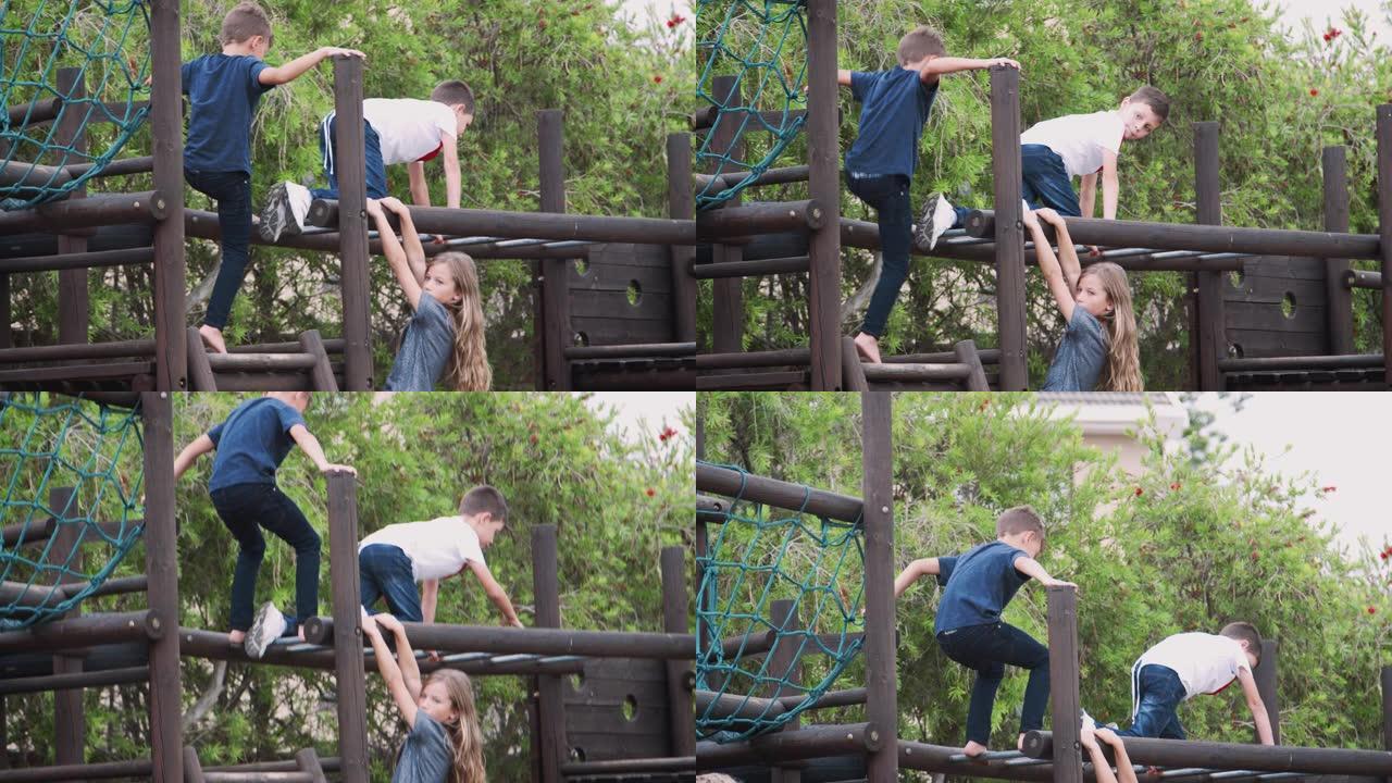 一群孩子在公园里和朋友在攀爬架上玩耍