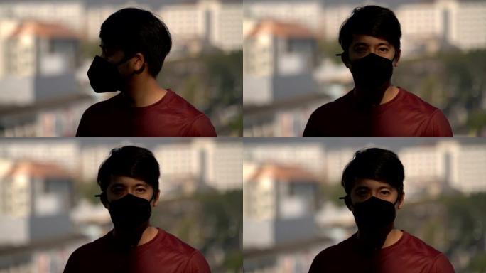 亚洲男子戴污染面具半脸阴影