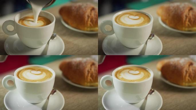 一杯咖啡和一小盘羊角面包制成的精美构图的肖像，而酒保则倒入caffee。