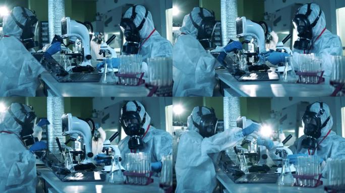 穿着危险品服的研究人员正在实验室检查探针。新型冠状病毒肺炎，冠状病毒概念。