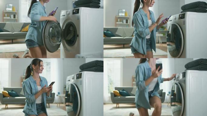 美丽的年轻女子坐在洗衣机旁边的膝盖上。她给洗衣机装了脏衣服，并用智能手机配置了洗衣机。在客厅拍摄，室