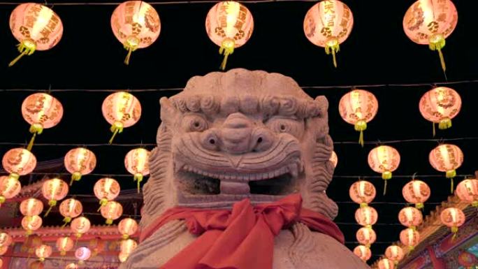 农历新年和中国红灯笼在中国寺庙的守护狮子雕像