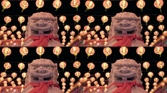 农历新年和中国红灯笼在中国寺庙的守护狮子雕像