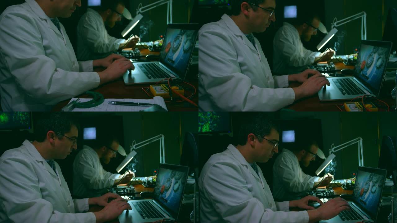 男性机器人工程师在4k办公桌上使用笔记本电脑