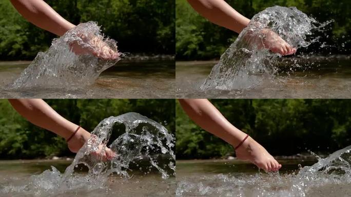 慢动作: 顽皮的年轻赤脚女人踢玻璃山河水。