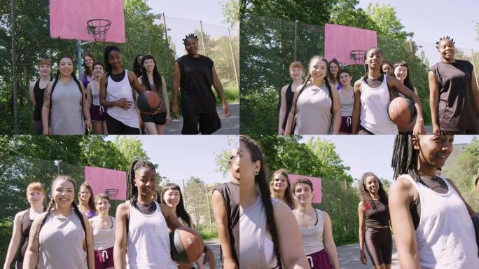 自信的女子篮球队在室外球场上
