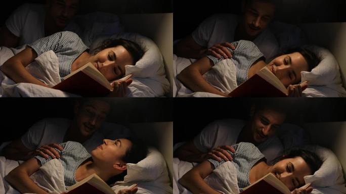 快乐的女人躺在床上看书