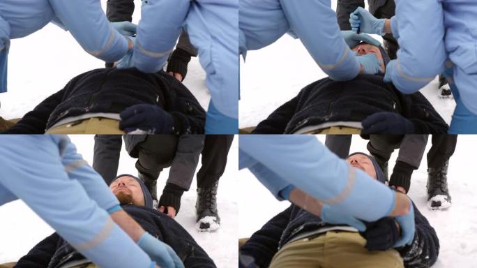 EMTs检查躺在雪地上的人