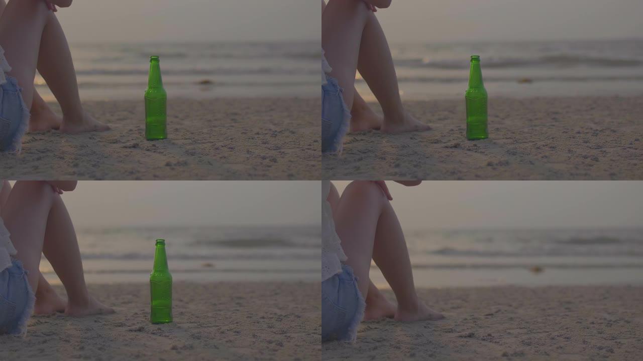 海滩上的手抓瓶女孩海边喝酒失恋孤独无助