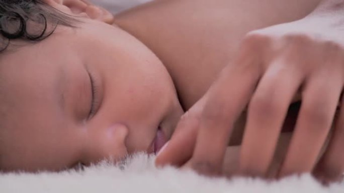 特写镜头，非洲母亲在卧室里睡觉时认识1个月的新生婴儿。幸福的爱的家庭。家庭关系。家庭时刻概念。
