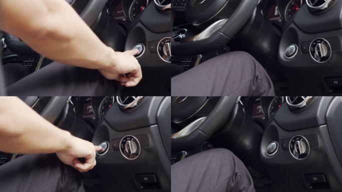 亚洲男子手按汽车启动发动机按钮。