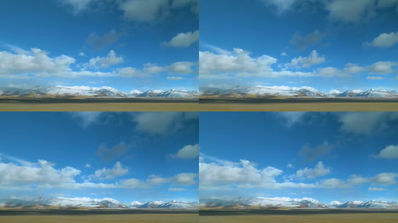 火车窗提供了平原和白雪覆盖的山脉的美丽景色。