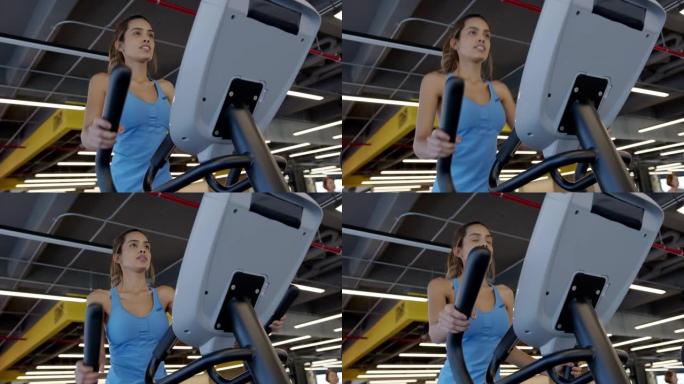 健身房椭圆机上瘦瘦的年轻女子