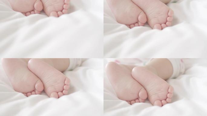 家里白色床上小婴儿脚的4k特写镜头