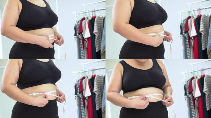 测量腹部周长的大型亚洲女性