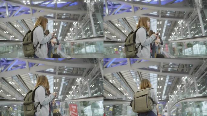 亚洲妇女在国际机场使用她的智能手机。
