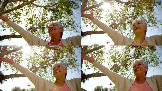 活跃的非洲裔美国高级女性在疗养院花园中进行瑜伽的低角度视图